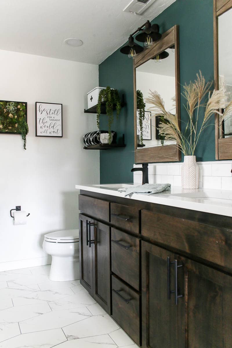 vanity with white quartz and green accent wall