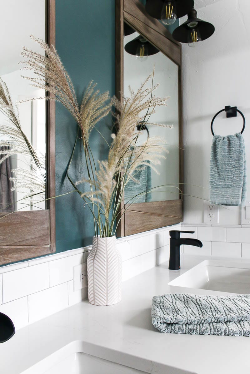 white quartz vanity with double sinks, double mirrors and countertop decor