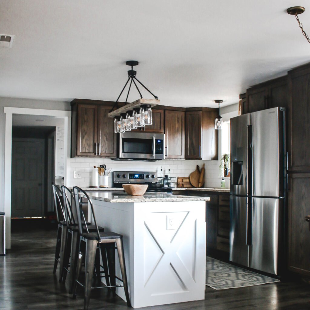 Kitchen with dark cabinets and white island