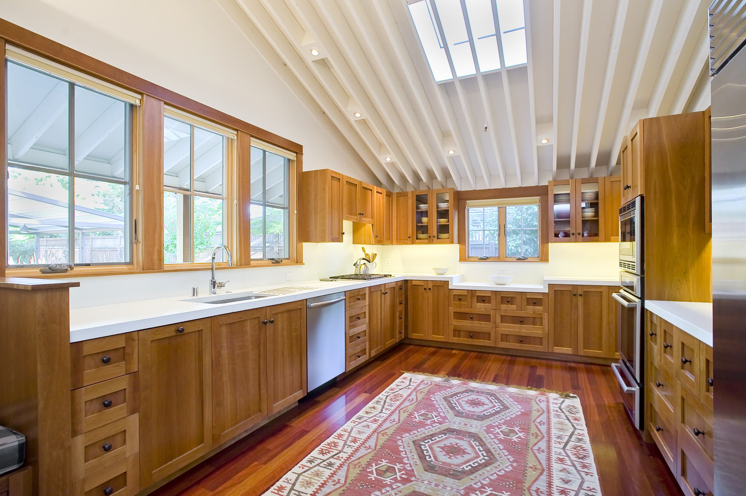 white quartz countertops in kitchen with wood cabinets