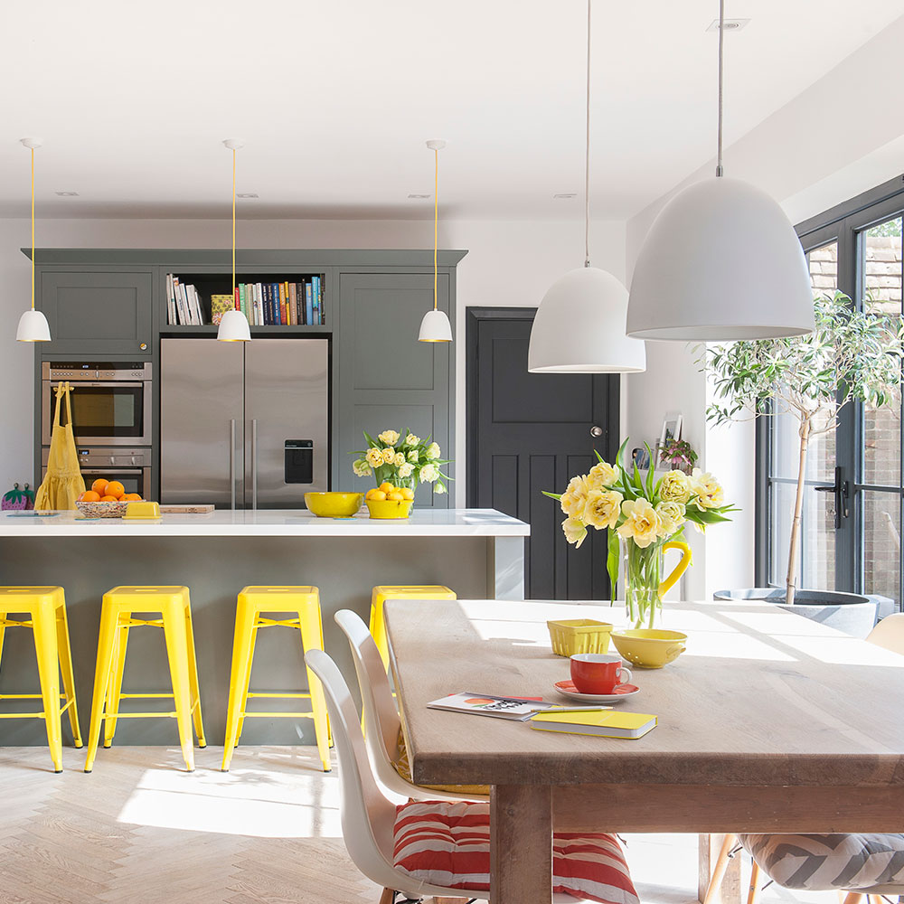 kitchen with gray cabinets and yellow bar stools