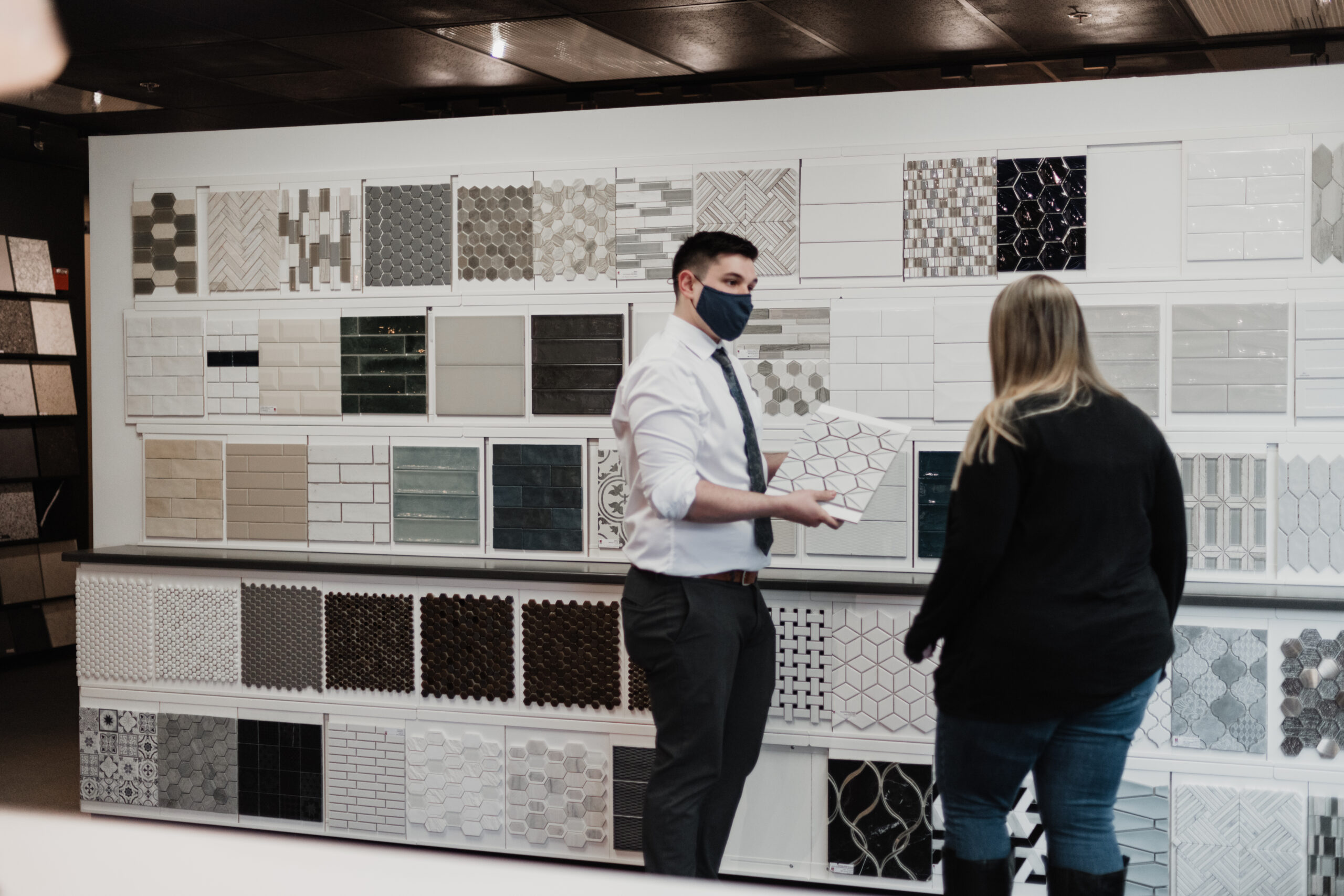 designer and client selecting tile in showroom
