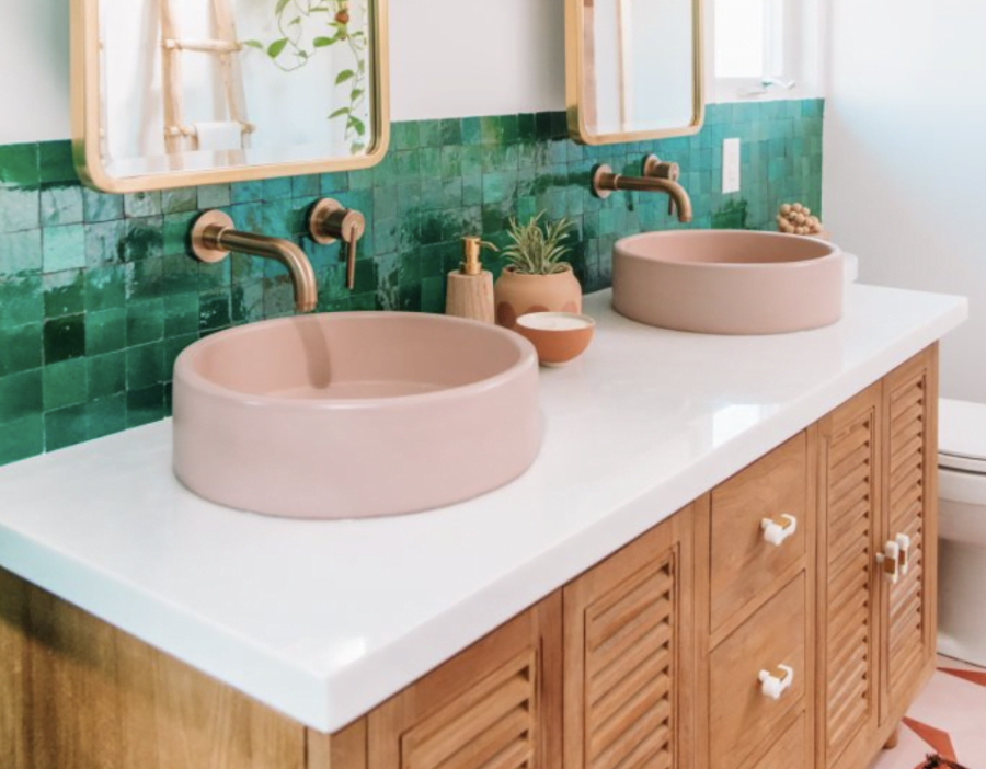 bathroom vanity with pink sinks, gold faucets and green 4x4 tile backsplash