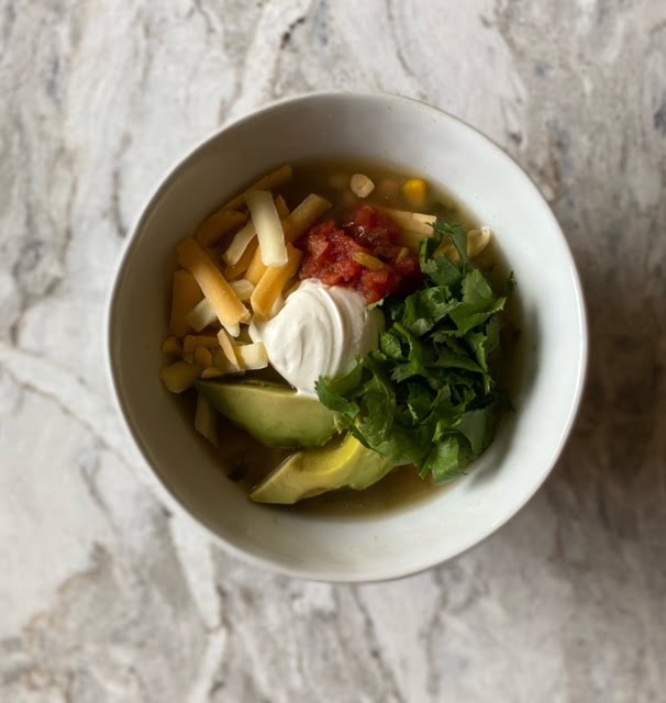 bowl with cheese, sour cream, avocados, and lettuce