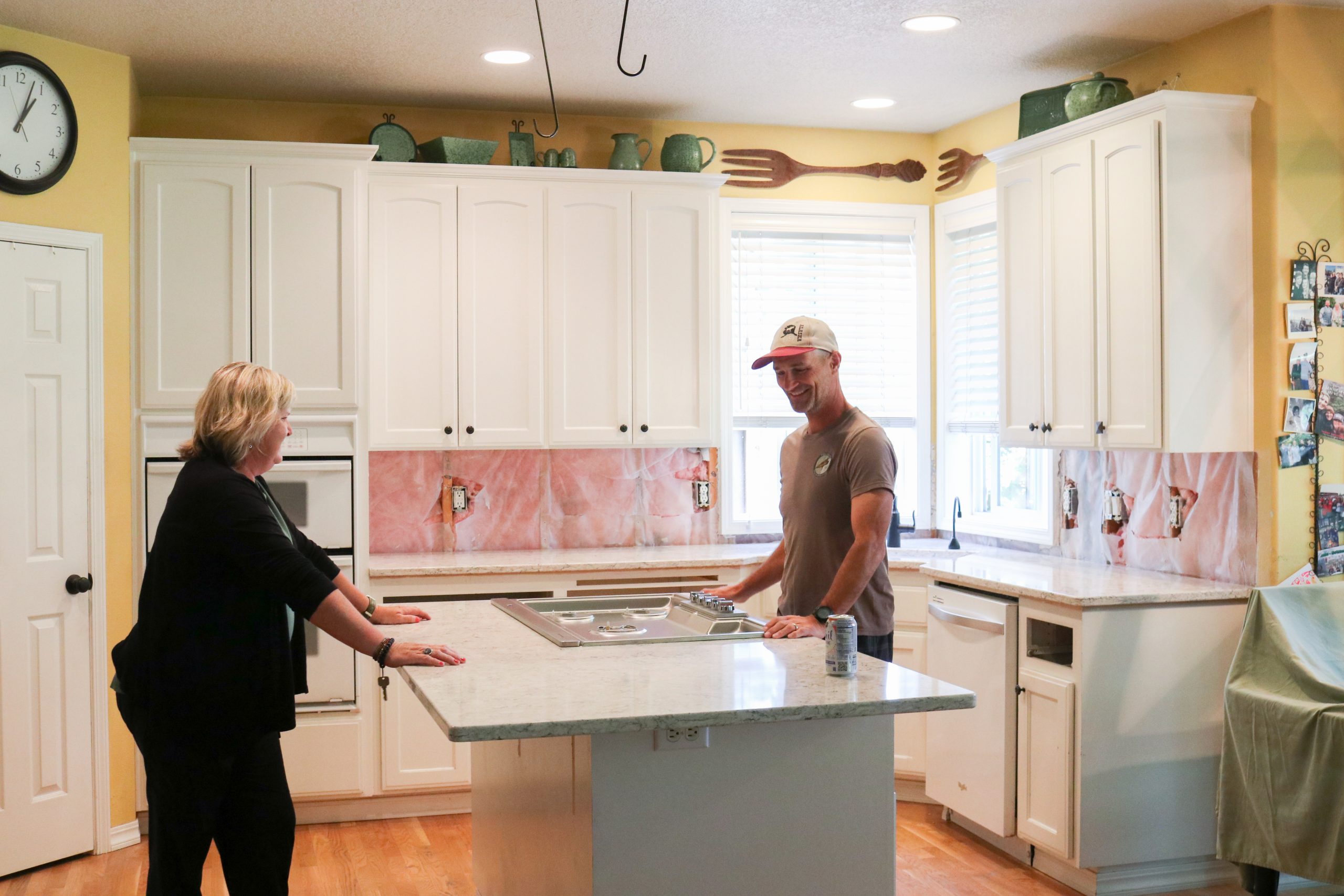 Happy customers looking at their newly installed kitchen countertop